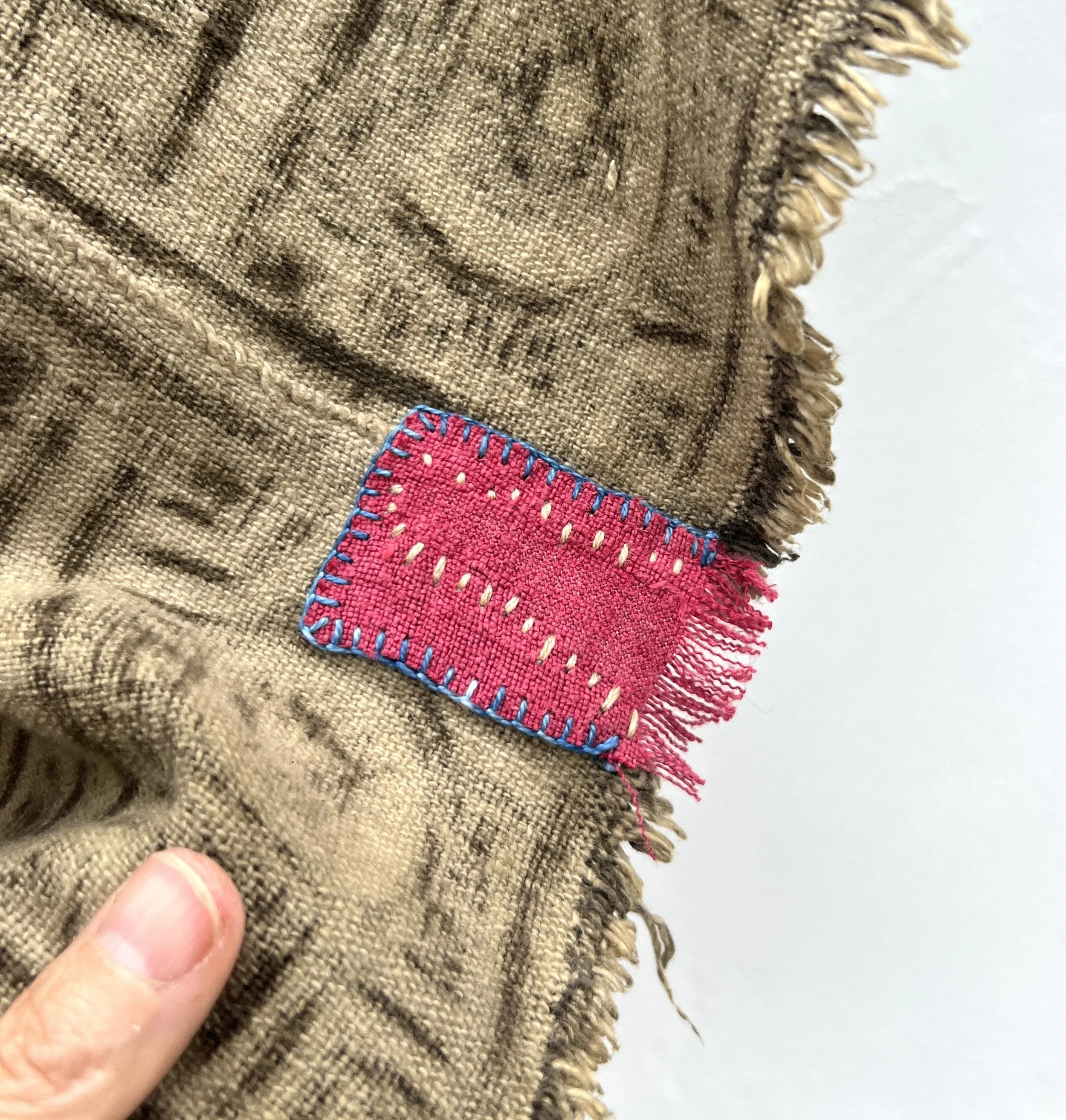 Visibly mended Mali mud cloth closeup patch