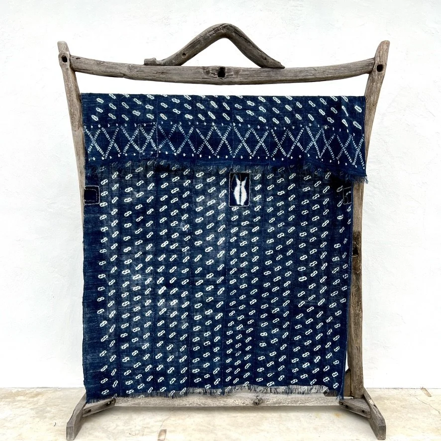 Indigo cowrie shell visibly mended hanging