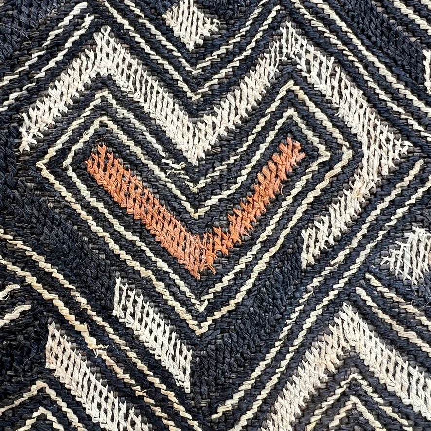 Square Kuba cloth from Congo with heart pattern in black, brown and beige closeup heart shape