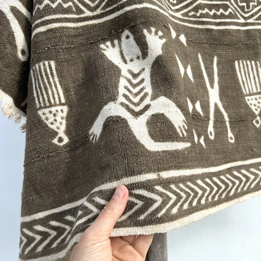 Animal mud cloth closeup with hand