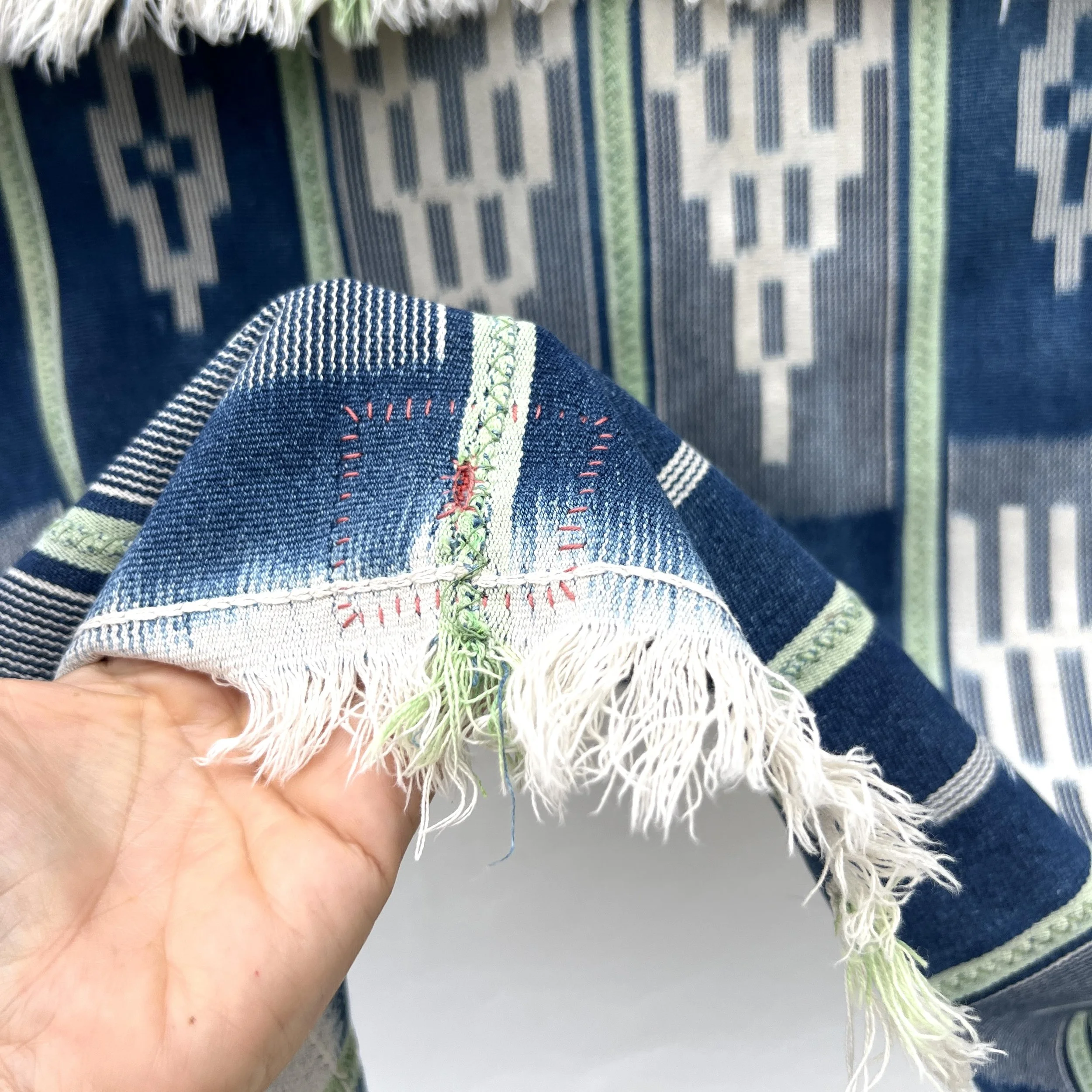 Baoulé blanket green stripes visibly mended closeup 2