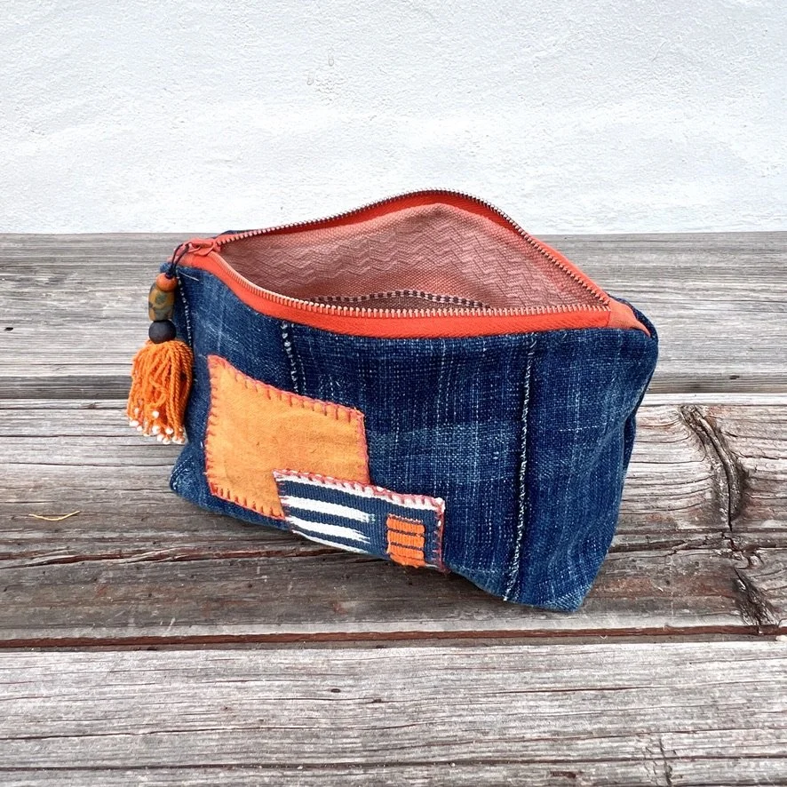 Indigo cloth pouch with orange patches open