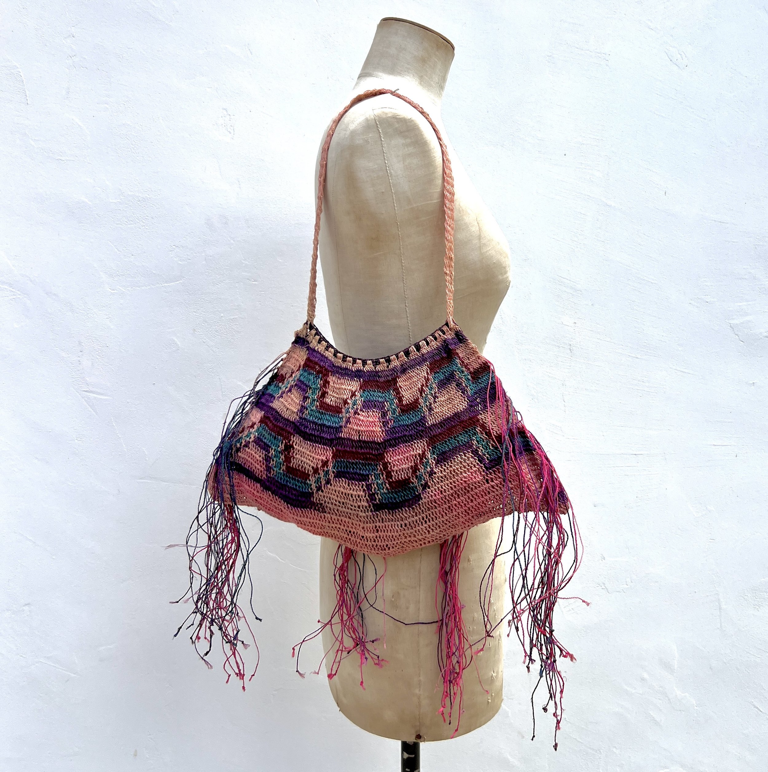 Pink Madang Bilum bag with fringe on model backside