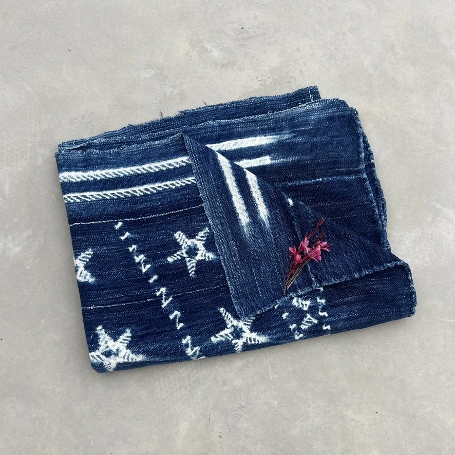 Mali indigo cloth star resist-dye pattern folded on ground