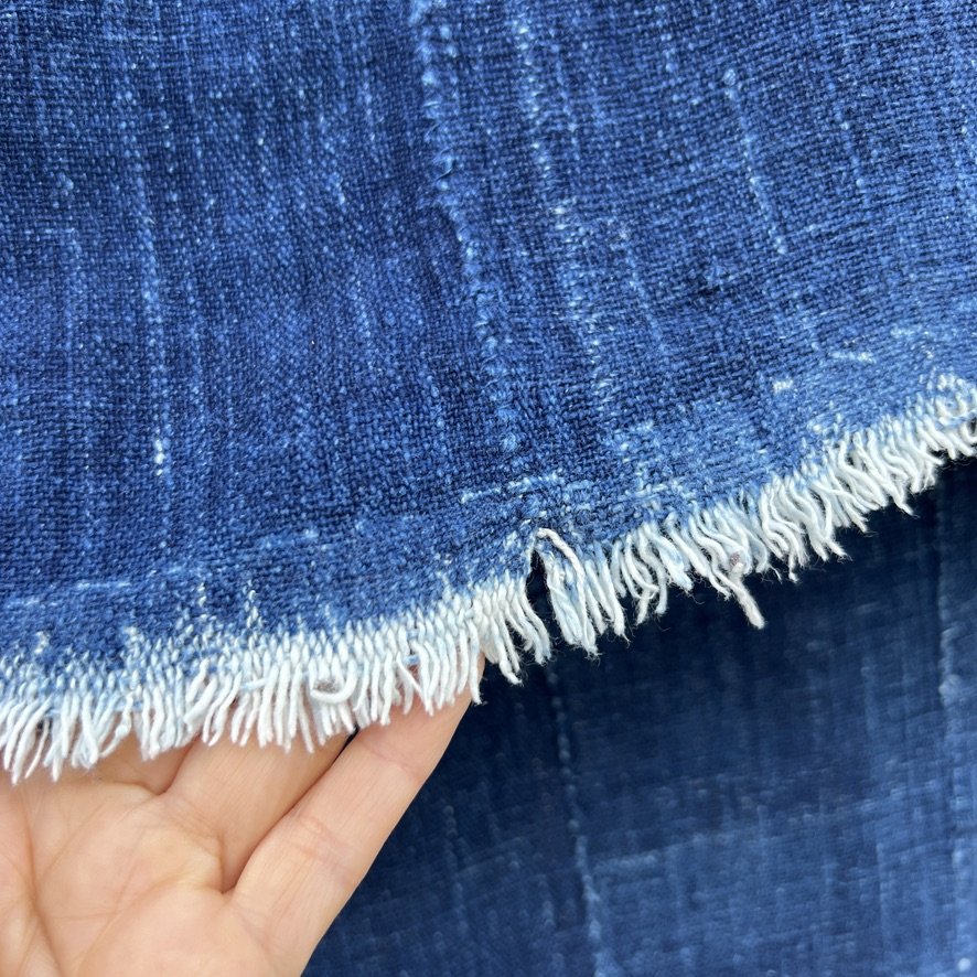 indigo cloth fish patch visibly mended closeup 2