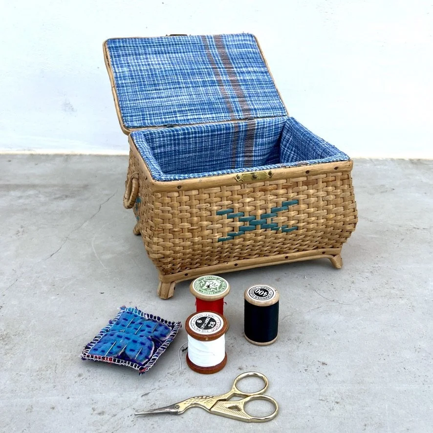 small vintage rattan sewing basket with sewing accessories open with accessories out