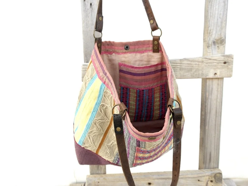 Aso Oke tote with different global textiles hanging inside