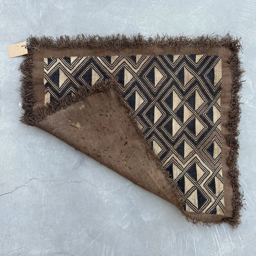 Square Kuba cloth from Kongo with geometrical pattern with corner folded over