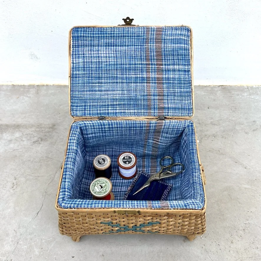 small vintage rattan sewing basket with sewing accessories open from above