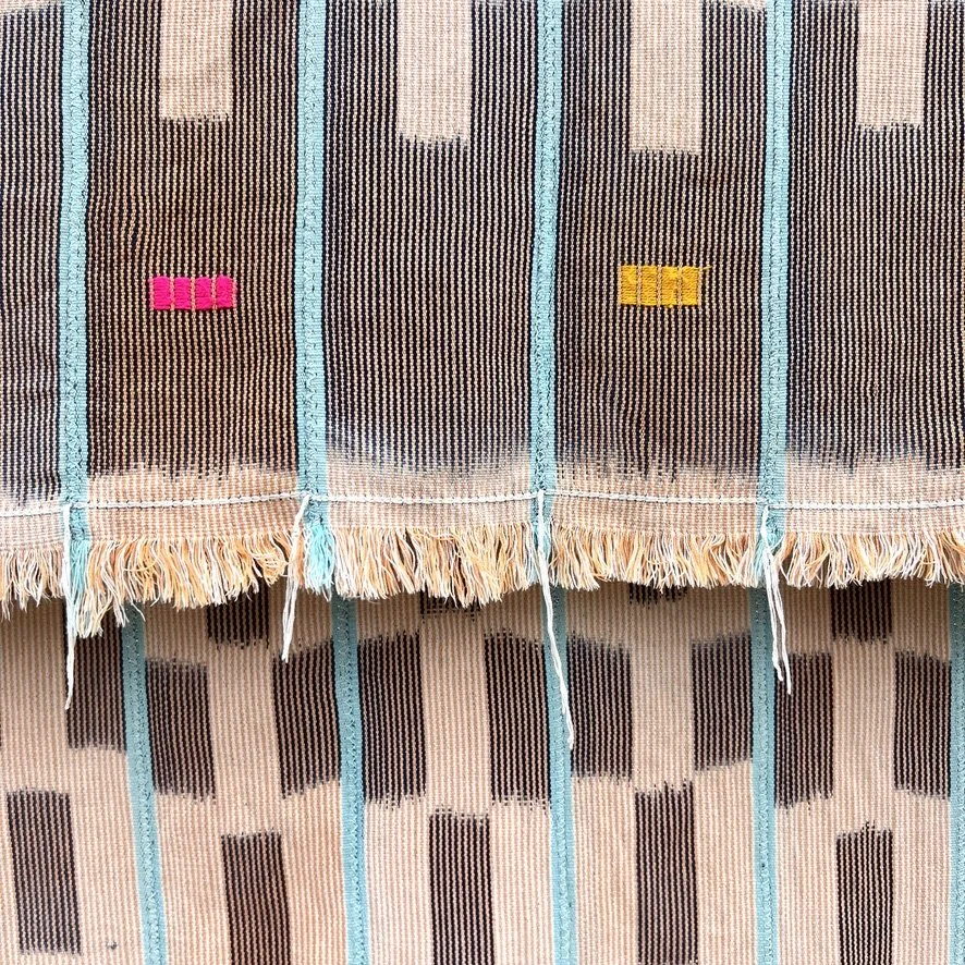 Baoulé blanket aqua stripes on salmon hanging closeup