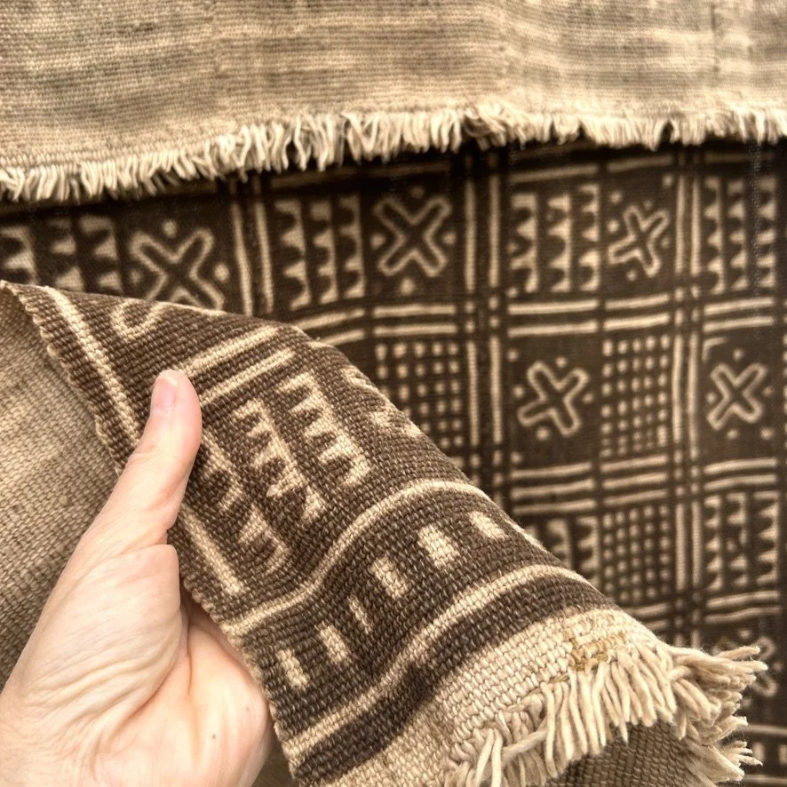 Mud cloth Mali resist-dye closeup with hand