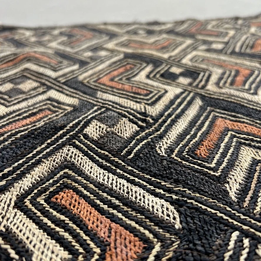 Square Kuba cloth from Congo with heart pattern in black, brown and beige closeup