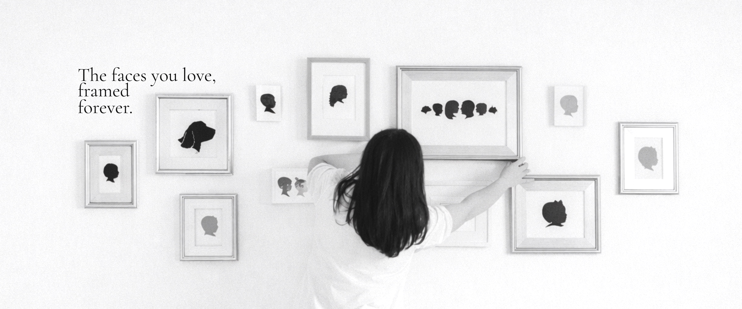 Child reaching out to touch framed silhouette portraits of faces on a white wall, alongside a quote about faces loved forever.
