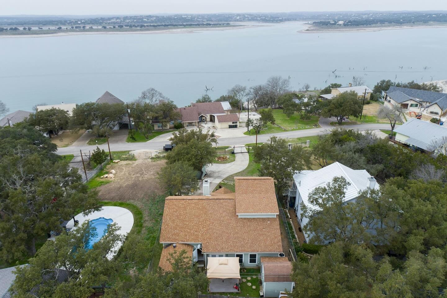 Fantastic Investment property opportunity facing Canyon Lake. Beautiful waterfront view from the large front porch. Plenty of storage and family play areas. Added bonus room on top of garage well suited for a guest suite not conveyed in original squa