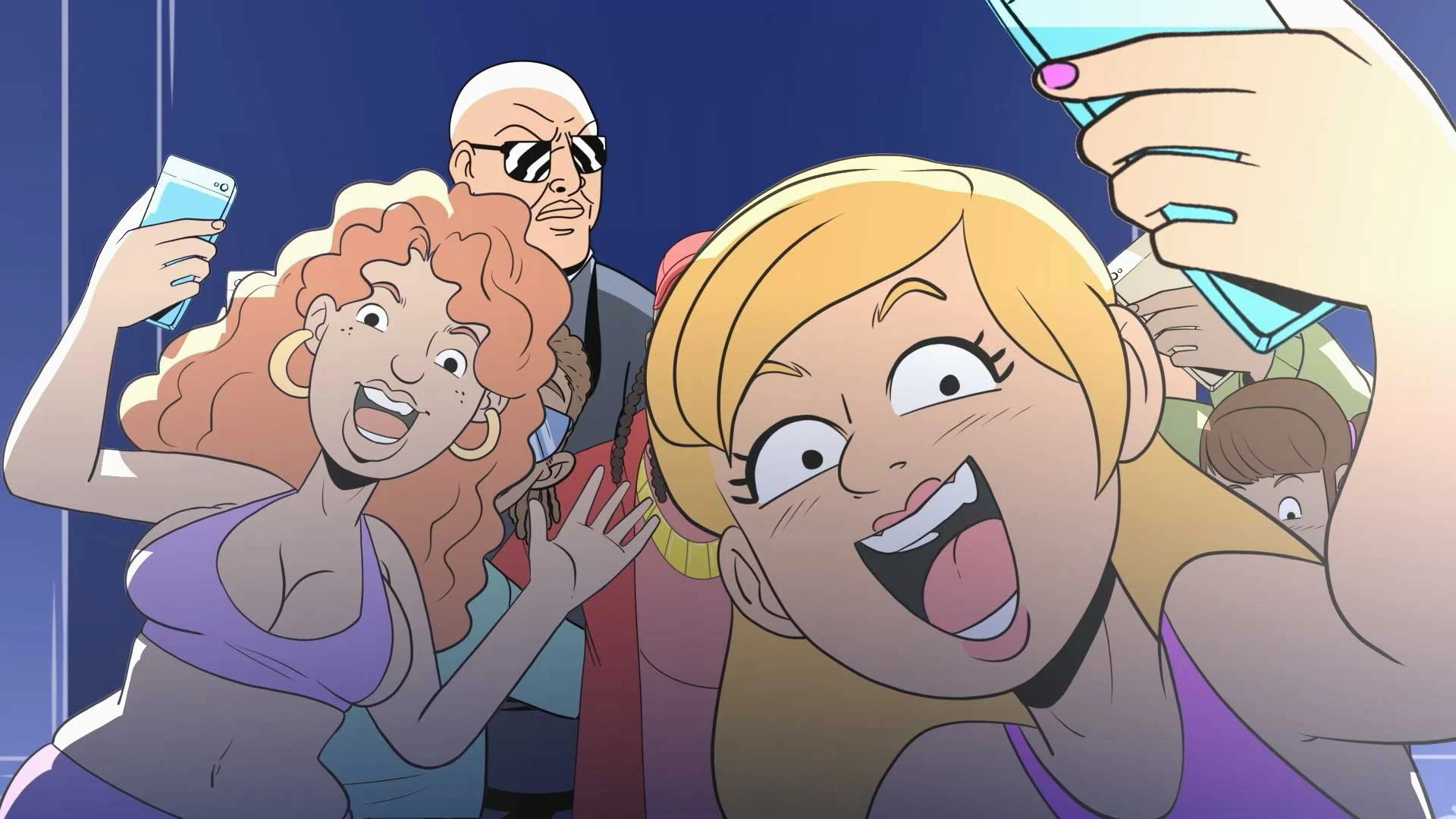 A group of animated women taking a selfie together, smiling and making excited faces, with a man standing behind them.
