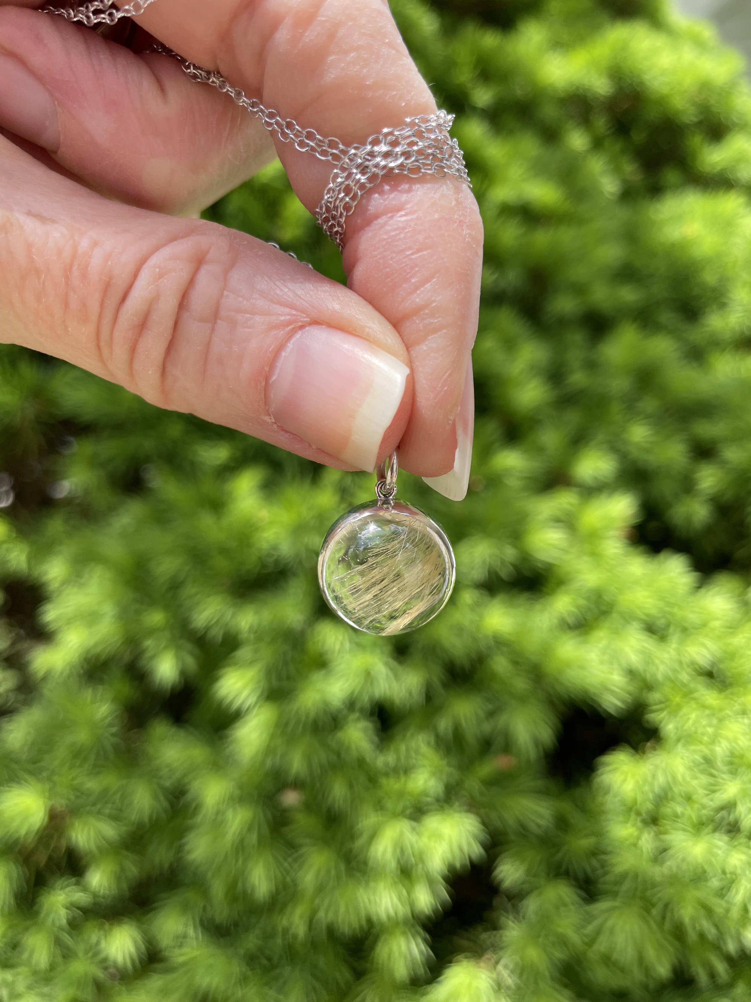 Gold rutilated quartz round pendant.jpeg