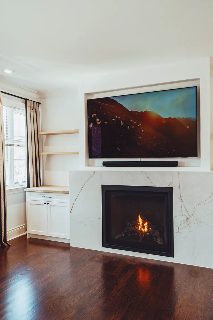 Modern fireplace and TV feature wall with built-in cabinetry