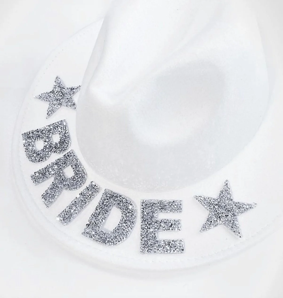 White cowboy hat decorated with sparkling Bride letters and stars.