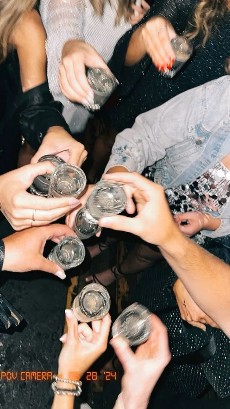 Overhead view of friends raising their glasses together for a toast.