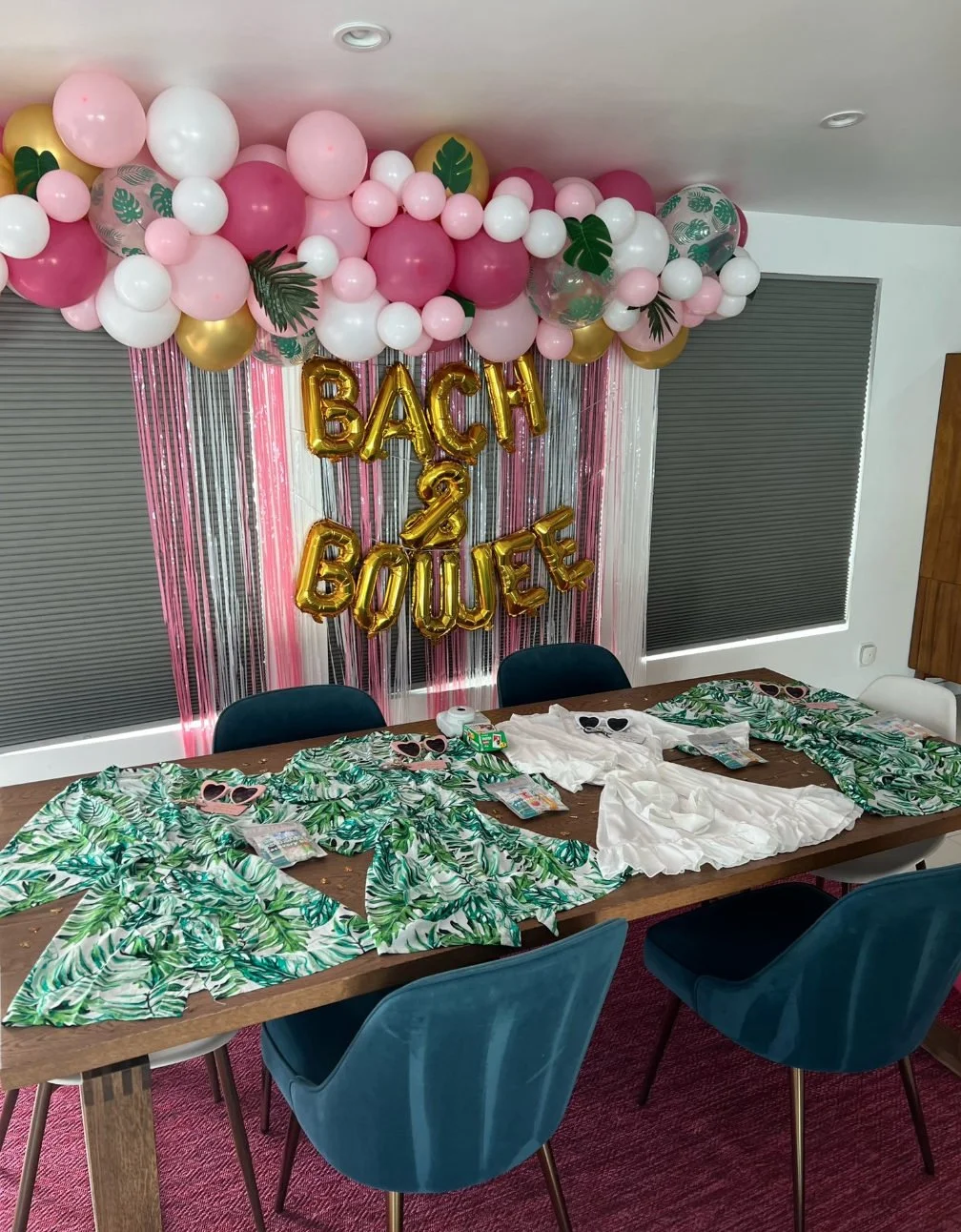 Pink, white and green balloon garland above gold Bach and Boujee letter balloons.
