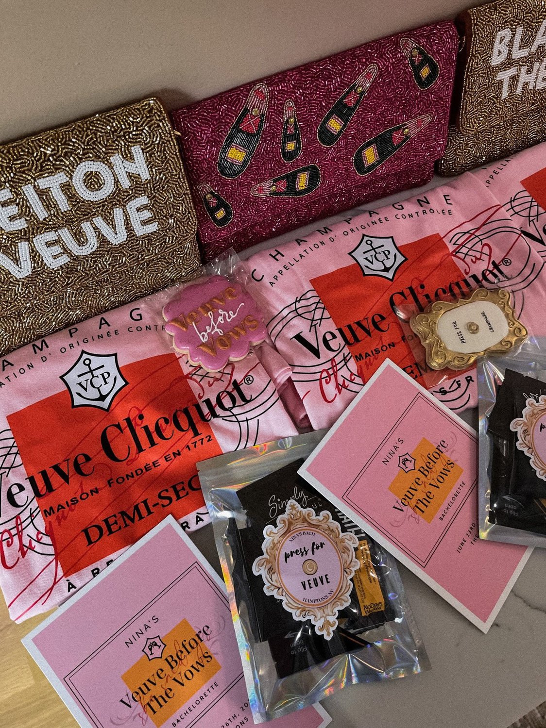 Pink and orange Veuve-themed bachelorette favors, cards and personalized party gifts.