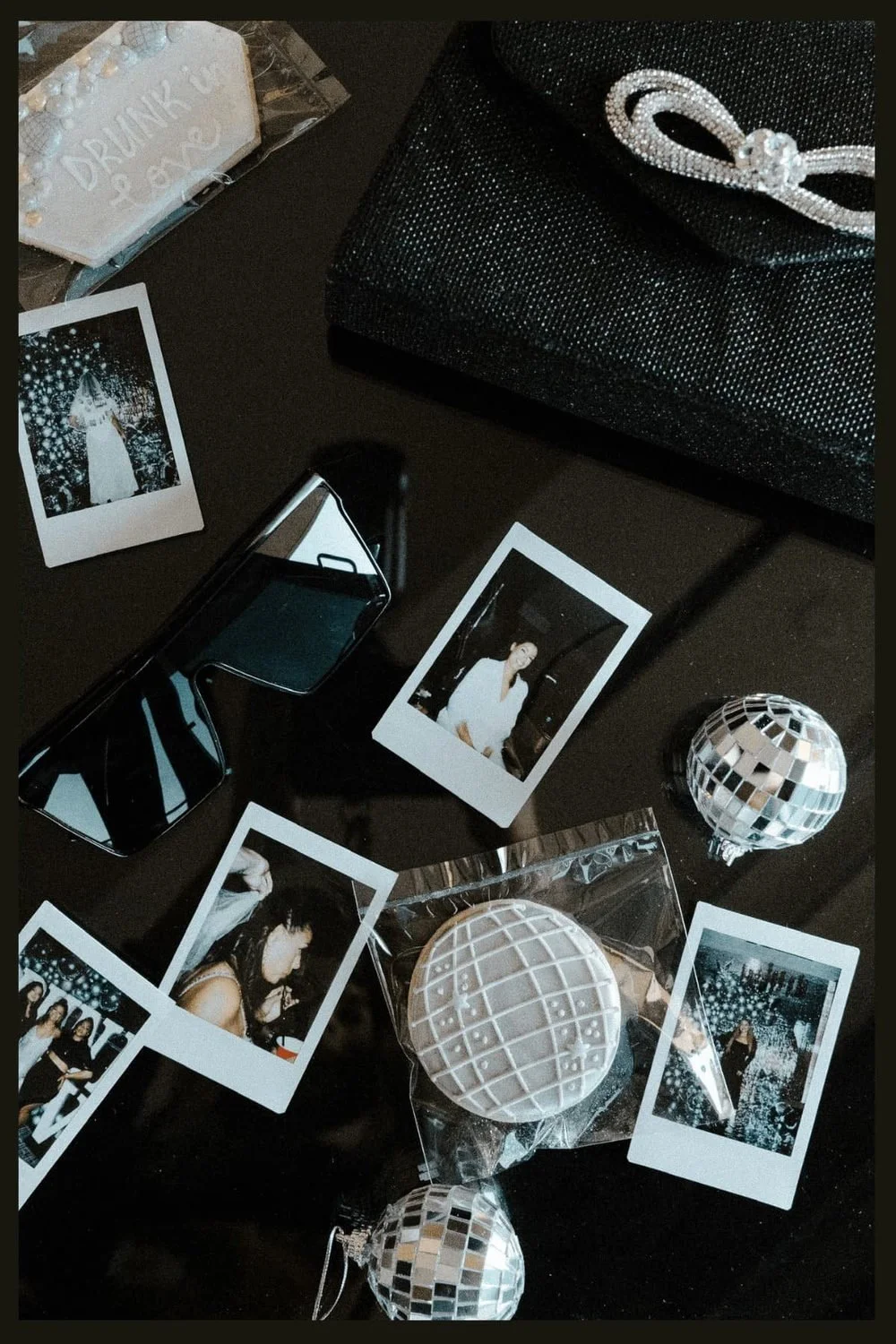 Bachelorette party favors with sunglasses, disco balls, instant photos and a beaded bow clutch