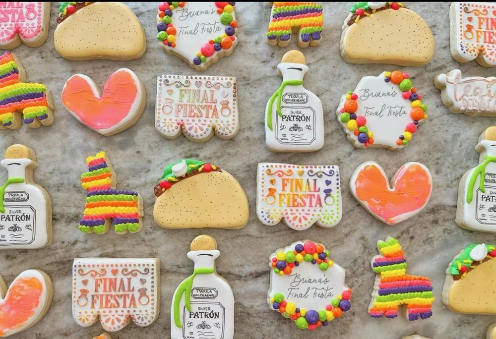 Fiesta-themed cookies shaped like tacos, hearts, tequila bottles and colorful stripes.