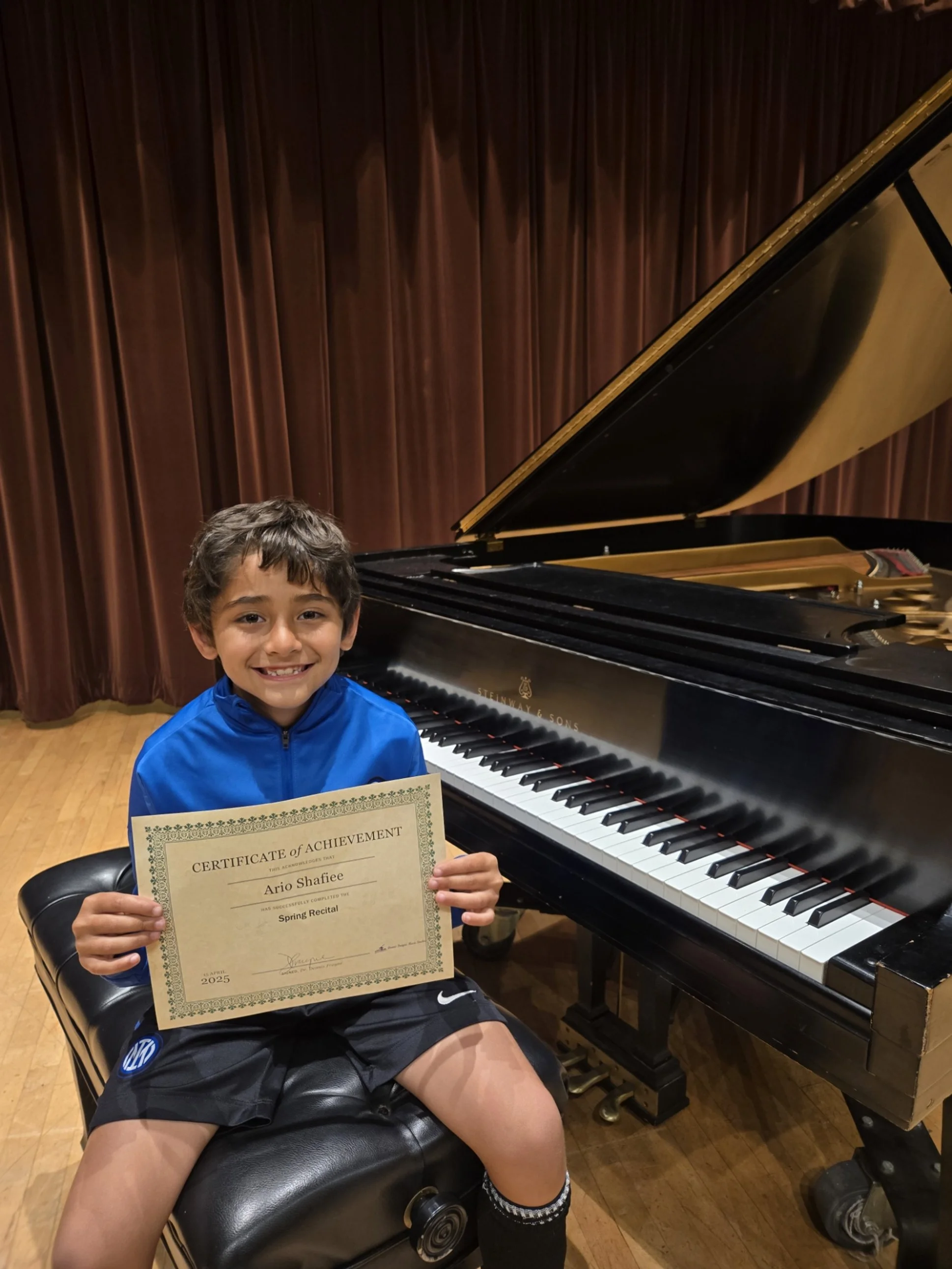 Piano student with certificate at recital.jpg