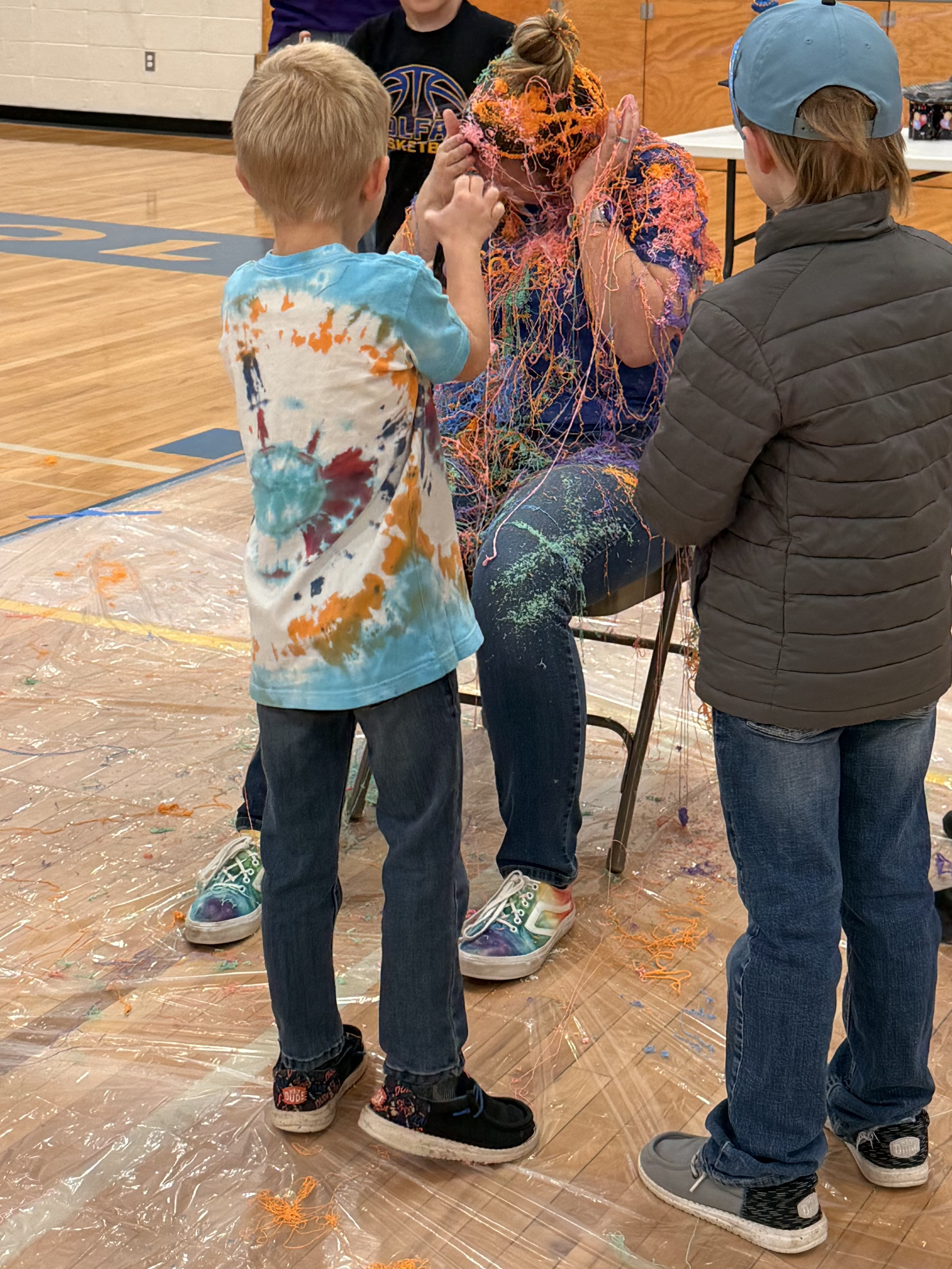 2026 Money War lower hall winner, Mrs. McNeilly's class, chose to silly string Mrs. Jennings!
