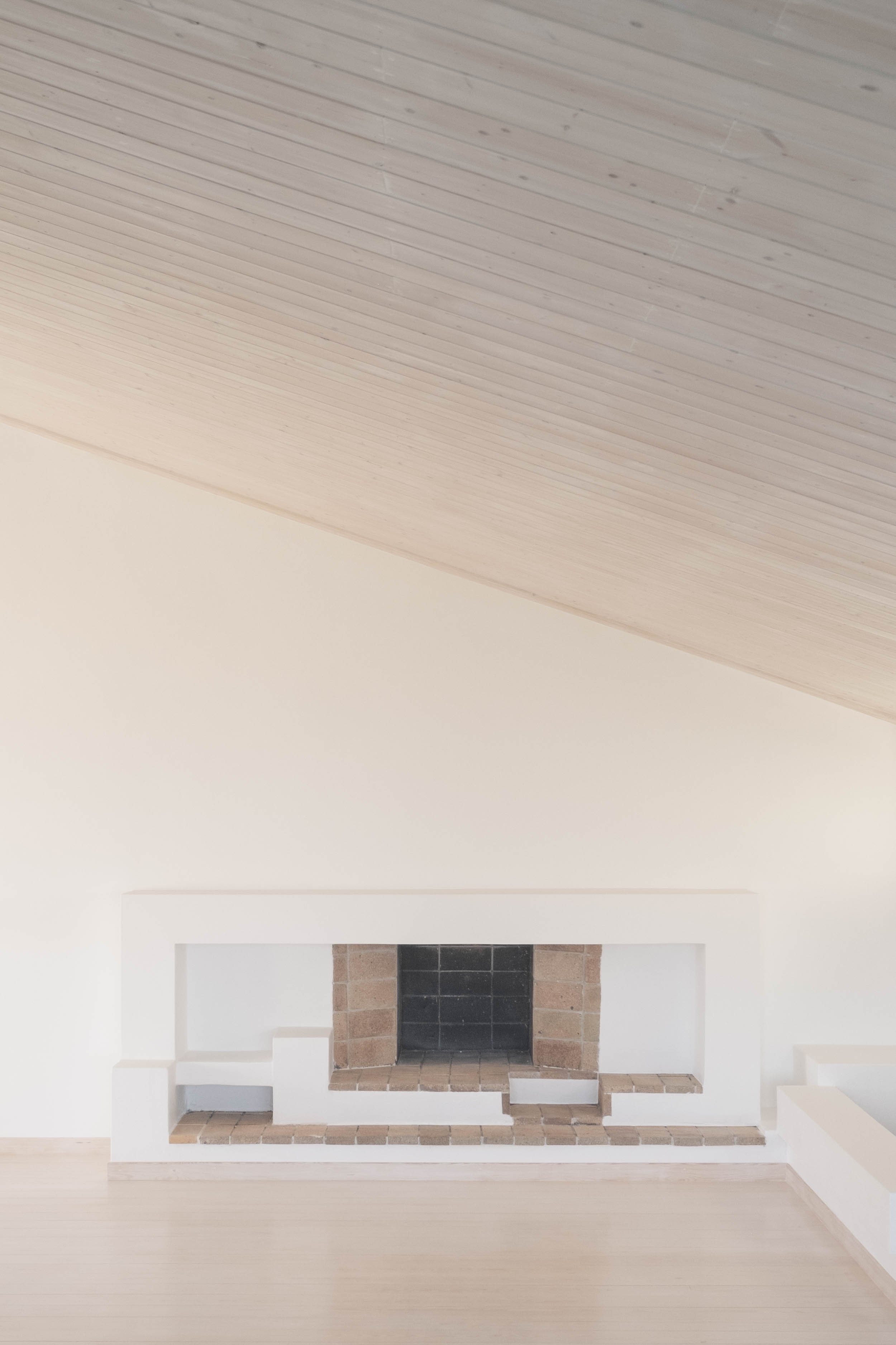 Inclume LTD — Light stained timber double height space and contemporary fireplace