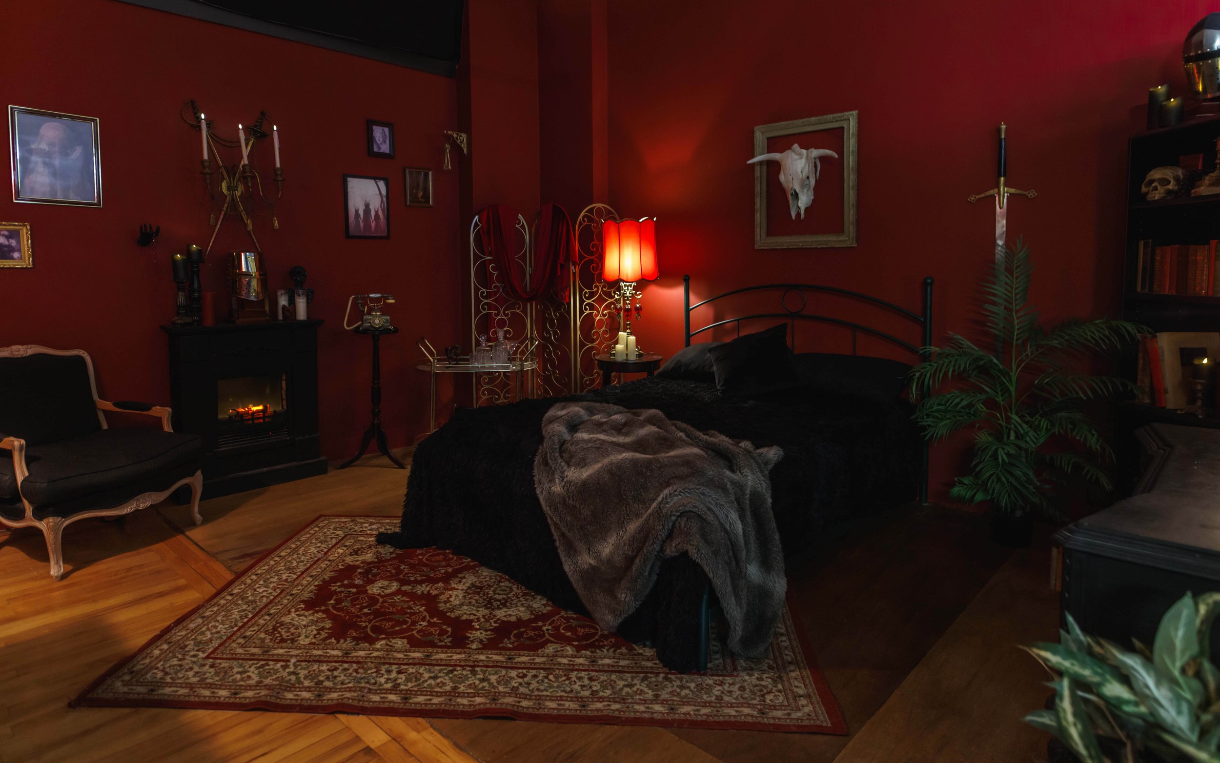 A moody gothic bedroom photography set featuring deep red tones, black decor, vintage details, and cinematic lighting.