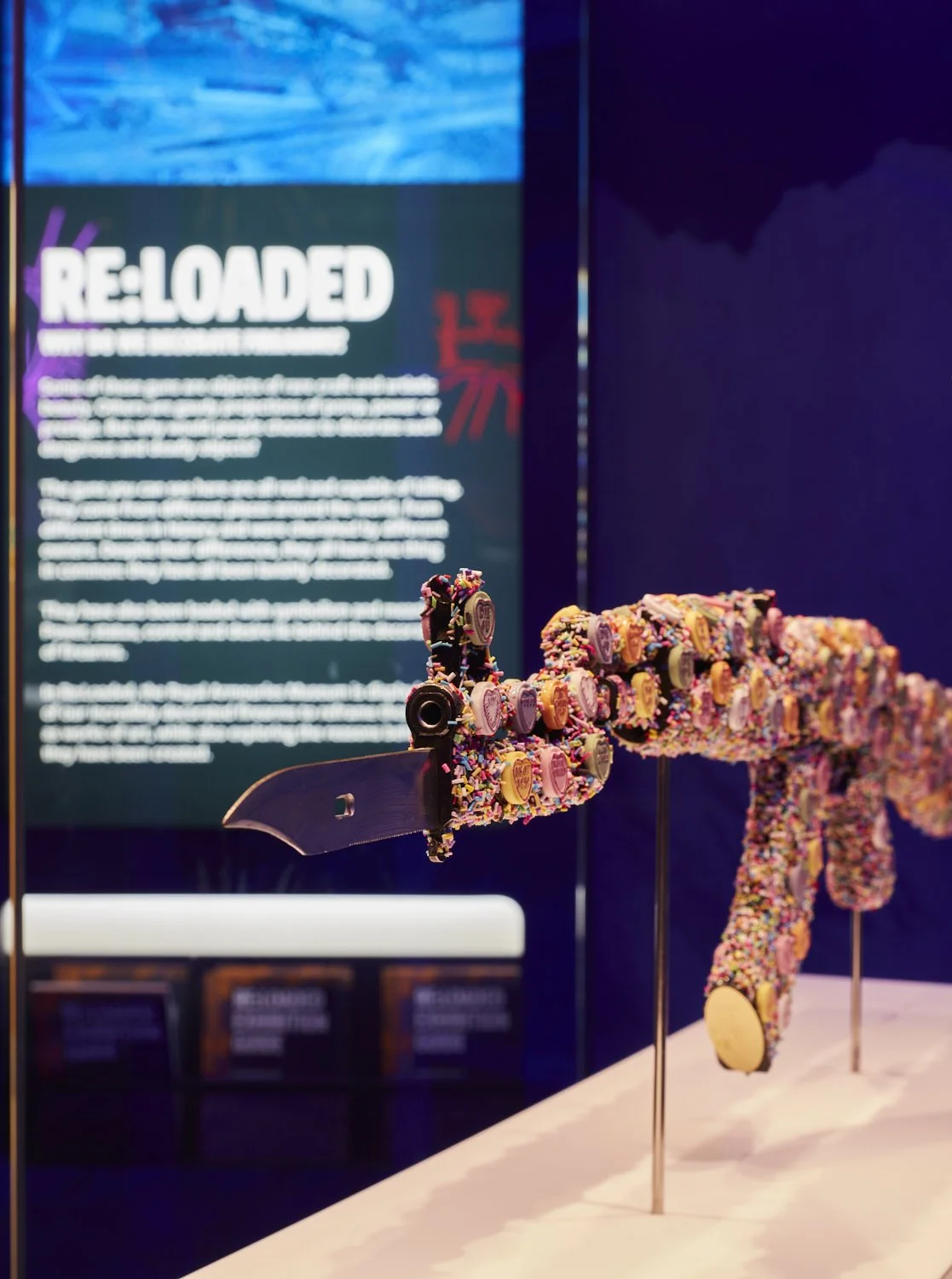 Bran Symondson-Baxter's artwork shows an AK-47 assault rifle decorated with love hearts; each message on the sweets changed to reflect the loss of innocence of many of the 'boy soldiers' the artist encountered.