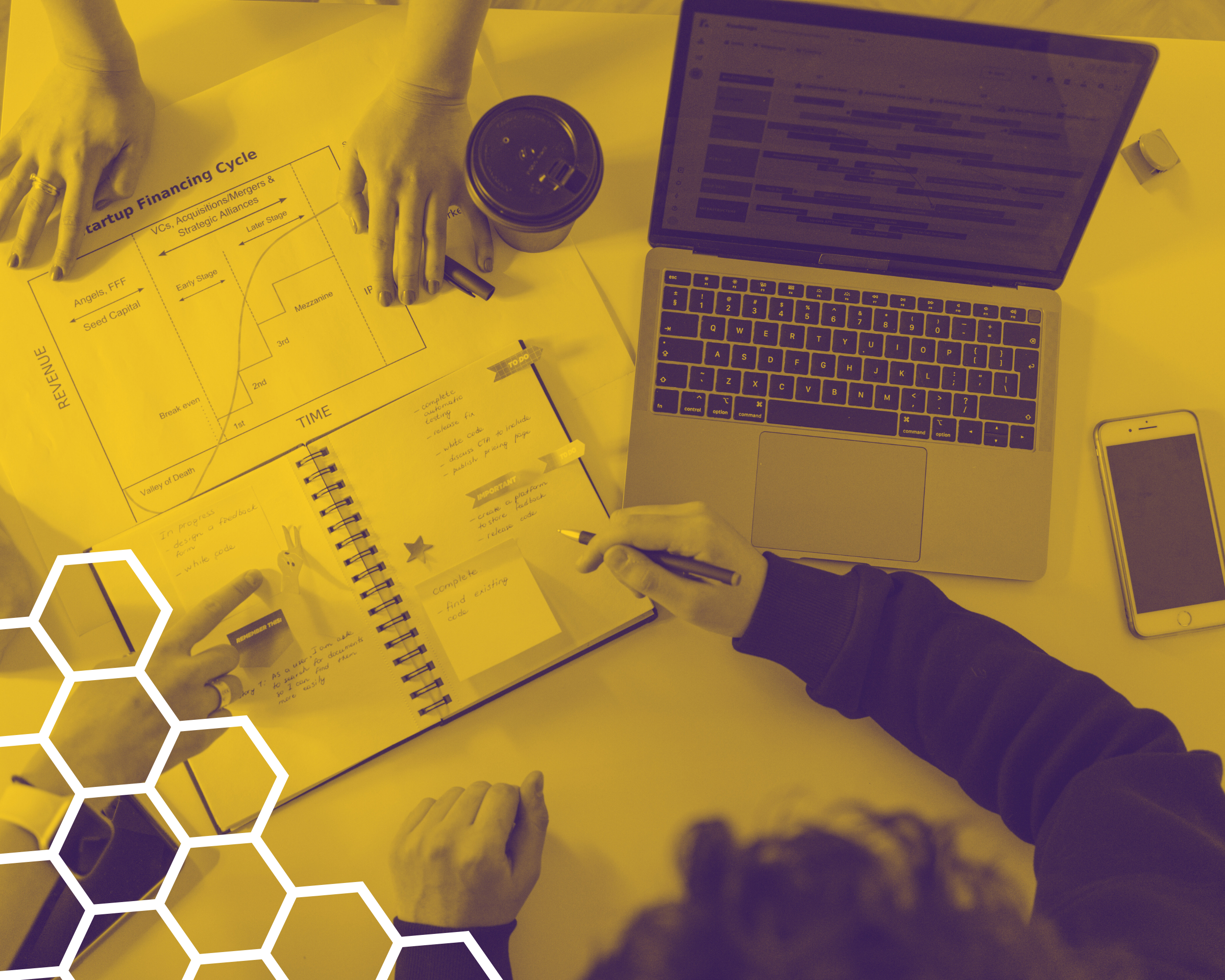 A mountain landscape with snow-capped peaks in the background, rolling hills in the middle, and a modern building on the hillside in the foreground.