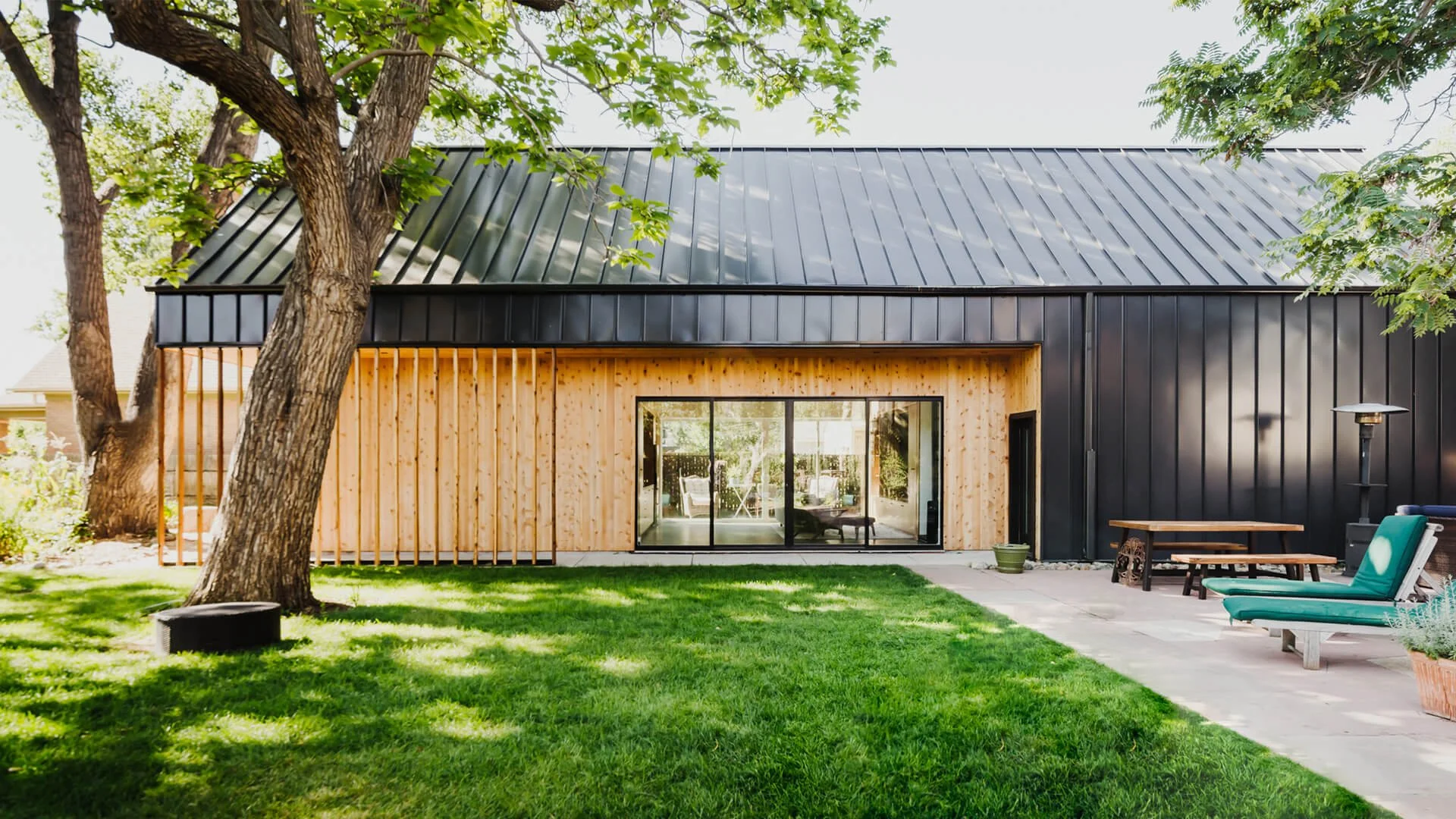 Modern ADU with wood slats and black metal siding in Denver, Colorado.