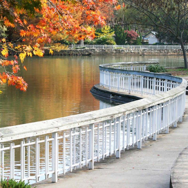 Scenic lakeside walkway with autumn trees in Raleigh-Durham, North Carolina.