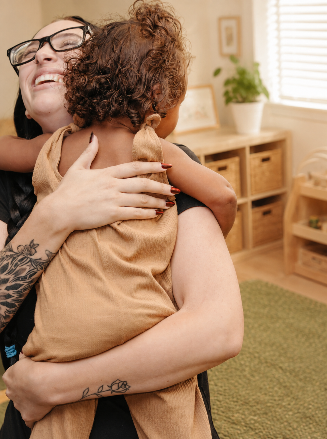 A young woman and a child hugging.