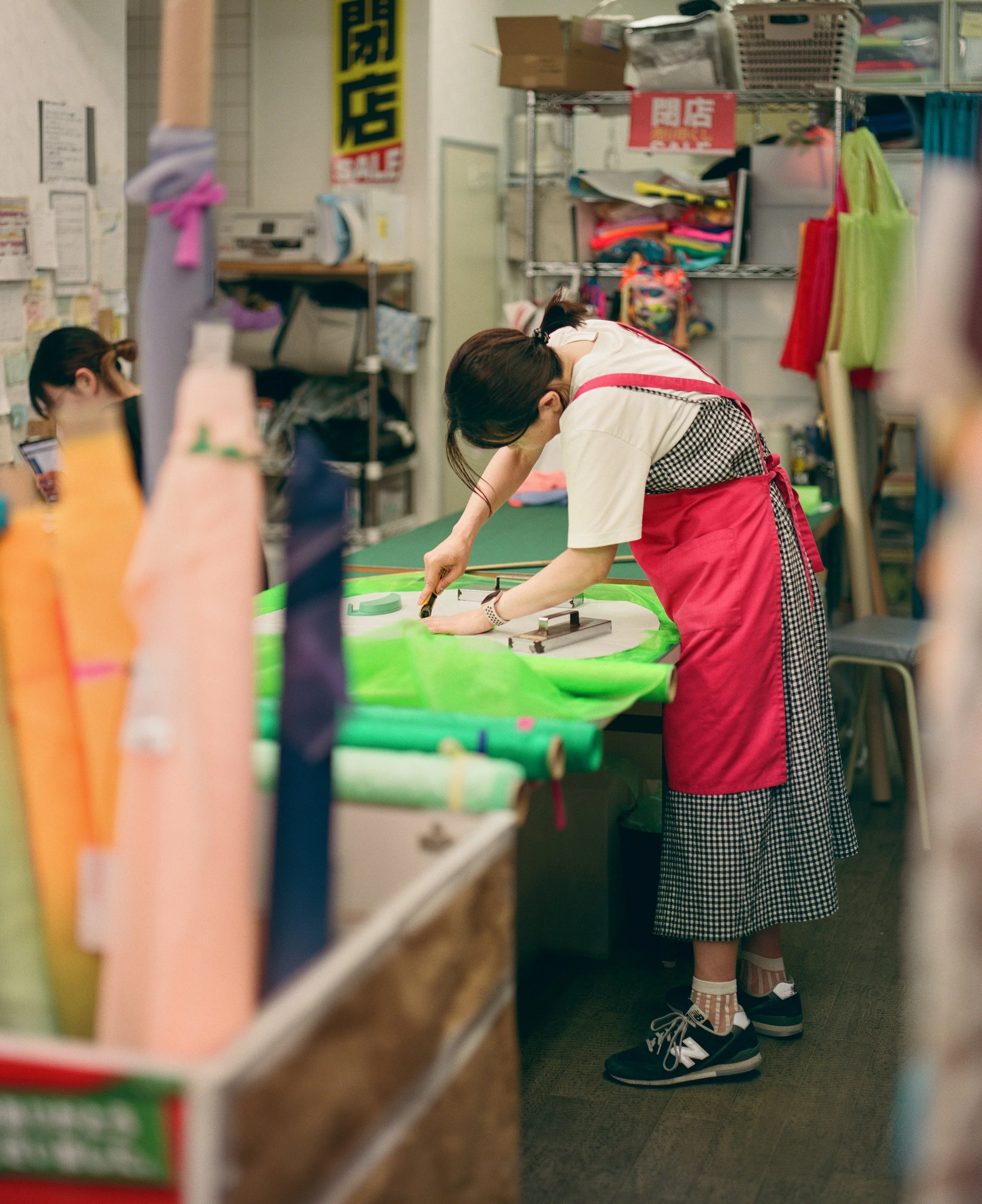 Worker at a shop in Nippori Fabric Town. I had hoped to capture many such photographs - people immersed in their work.

Nippori Fabric Town has hundreds of fabric and textile shops, each with its own speciality. 
