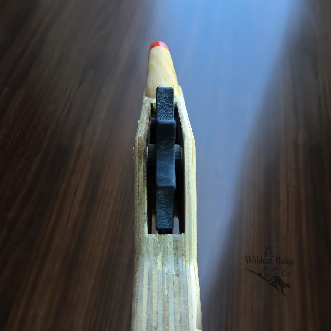 firing rubberband revolver with wooden backdrop