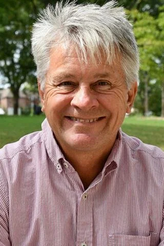 Portrait of Dr. Gregory Alexander outside on a sunny summer day.