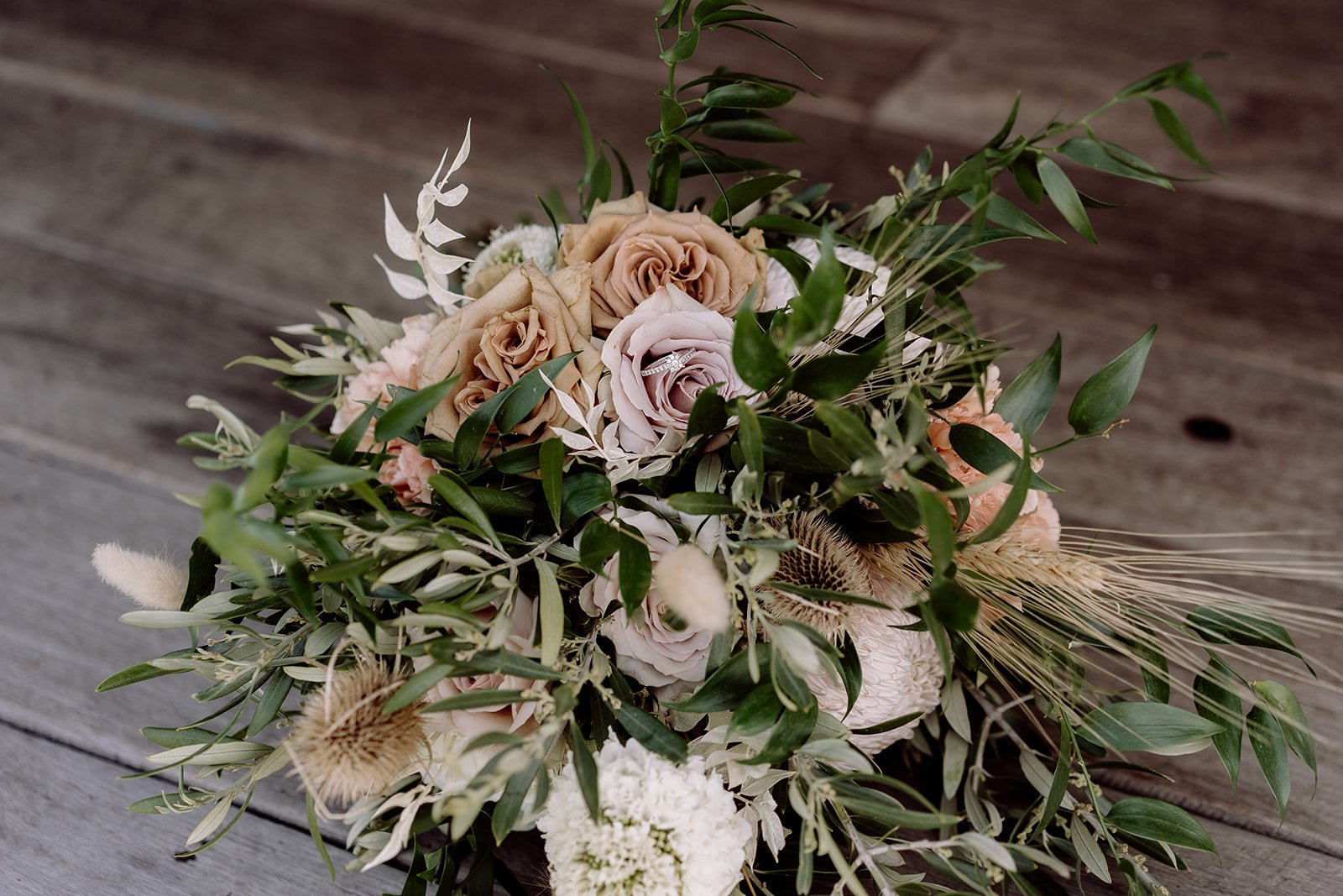 Dusty pink wedding bouquet with roses and greenery