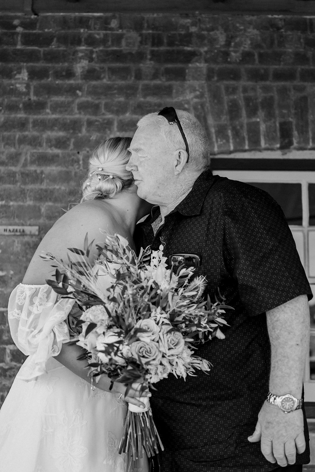 Father of the bride giving his daughter a hug after first look