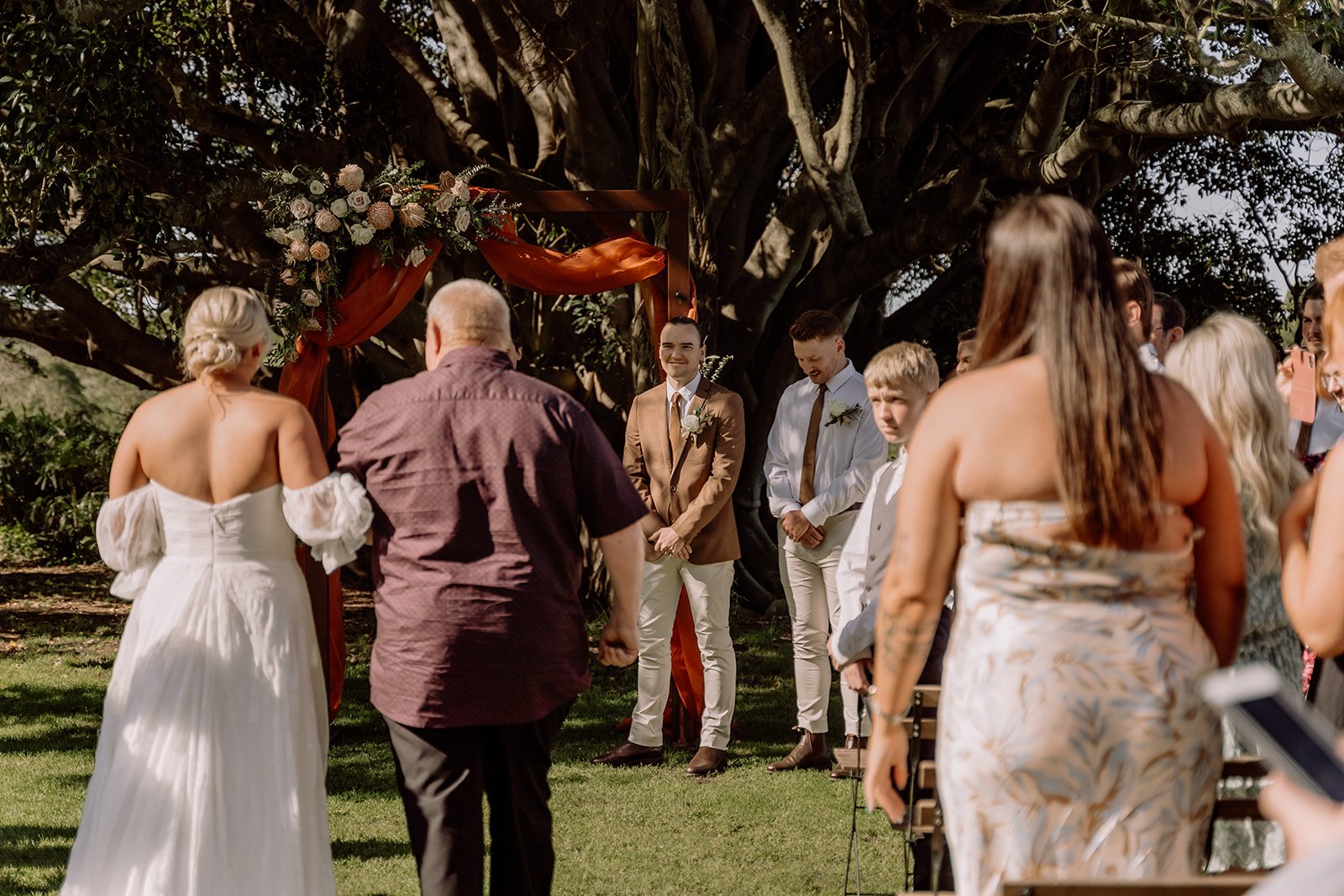 Bride walking down the aisle with her father at Tocal Homestead in front of grand fig tree