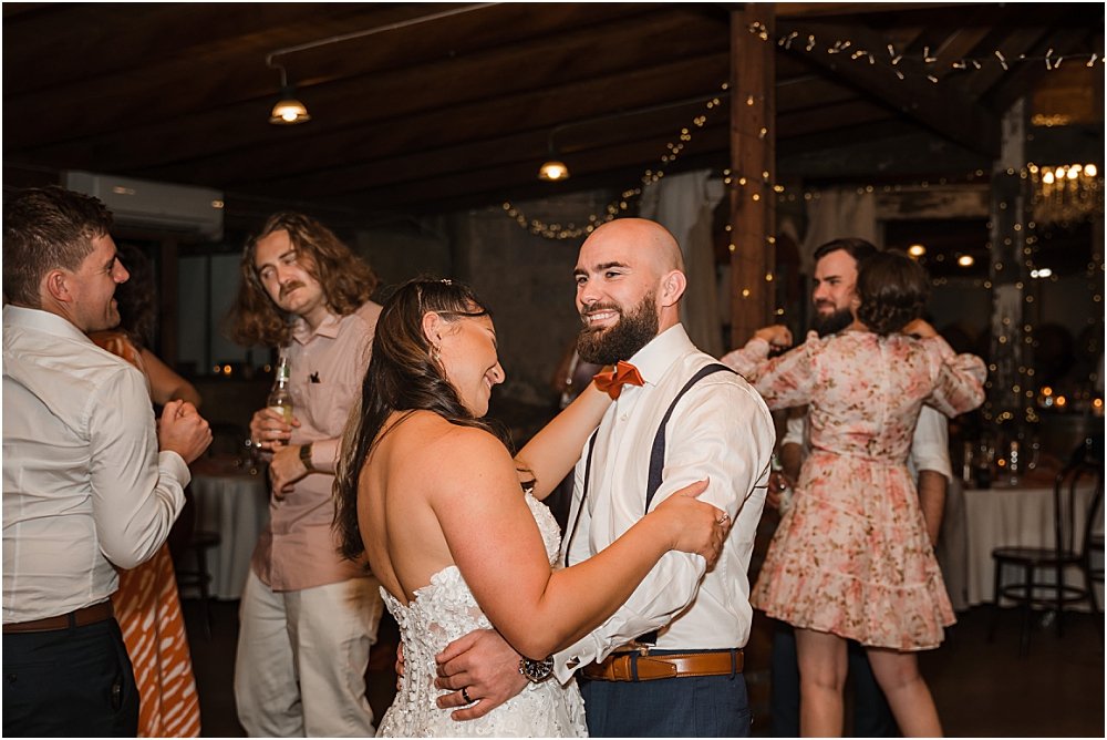 Bride and groom having first dance under fairylights at Peppers Creek Barrel room