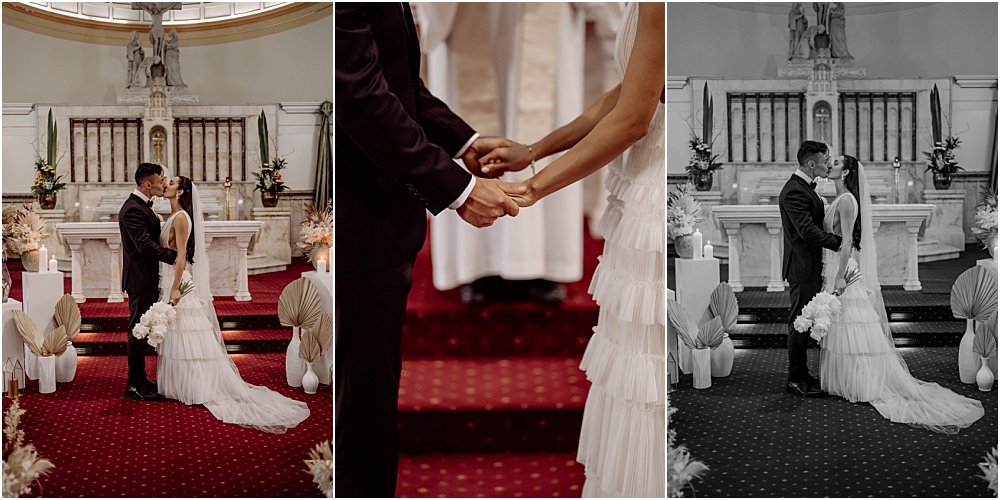 Bride and groom holding hands and sharing first kiss together