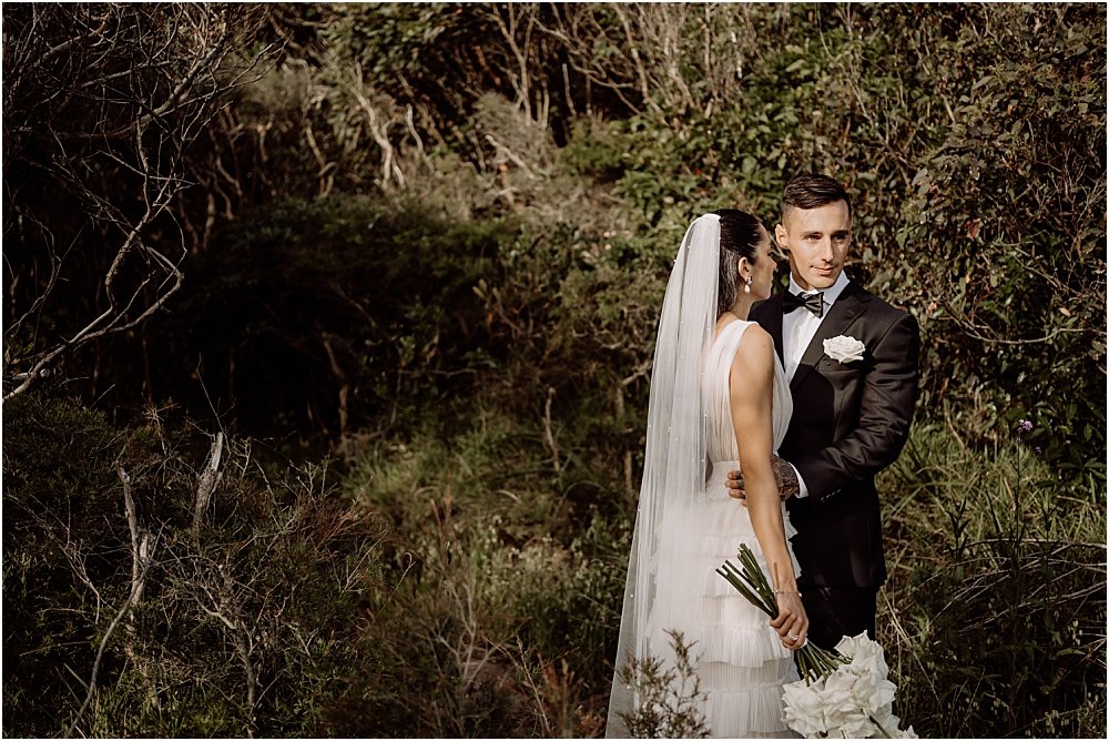 Bride and groom standing together in the bushland at Glenrock reserve in Newcastle NSW