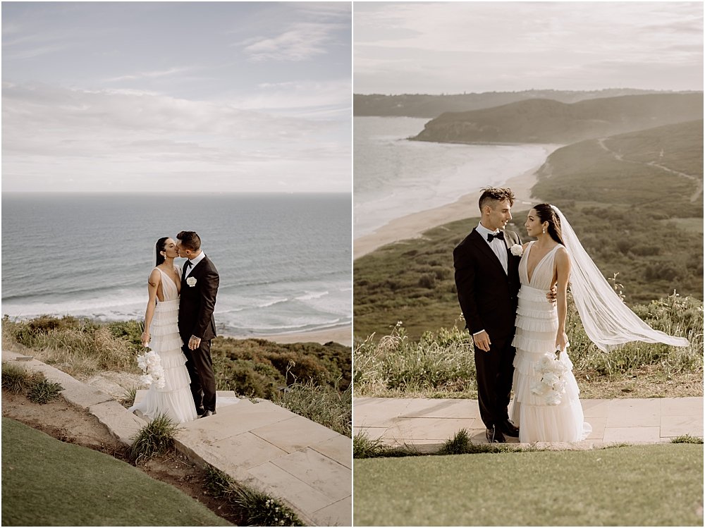 Bride and groom standing over lookout at Hickson Street in Merewether with veil blowing in the wind