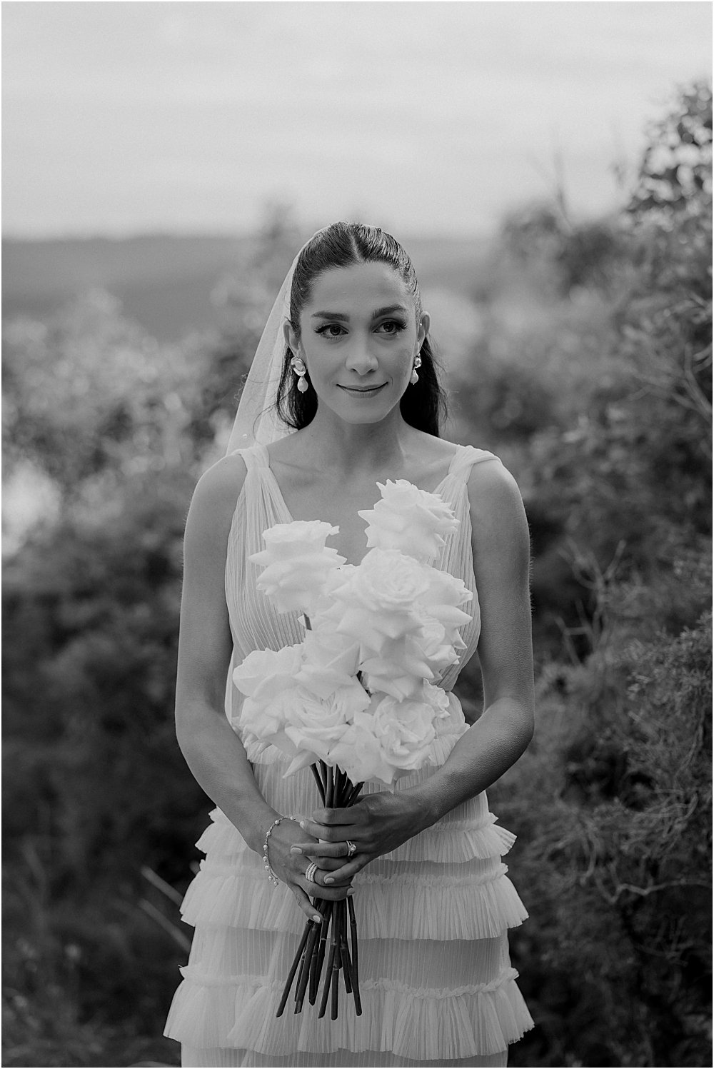 Bride holding wedding bouquet and standing in bushland at Glenrock reserve Newcastle NSW