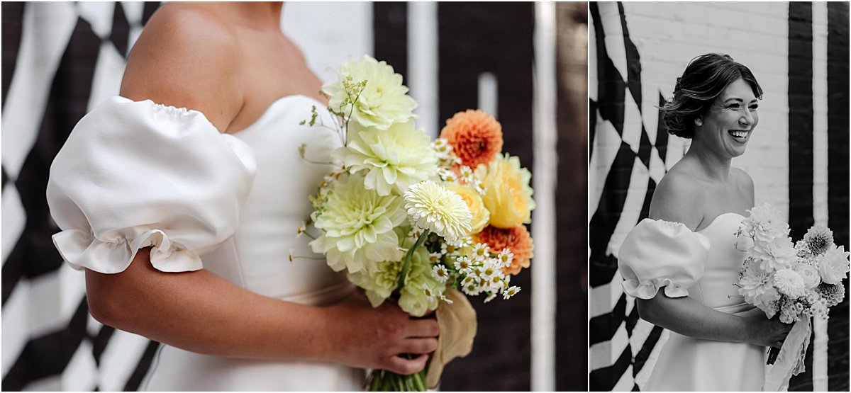 Bride standing in front of black and white mural at the Owens Collective in Islington, holding orange and yellow bouquet