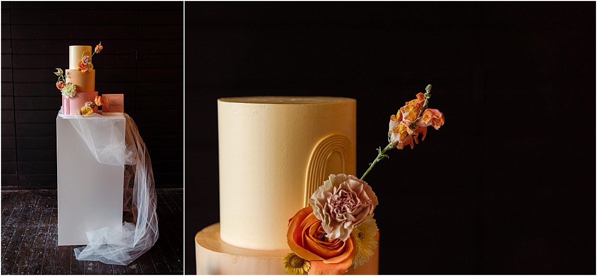 3-tier wedding cake in pink, orange and yellow with bright flowers covering