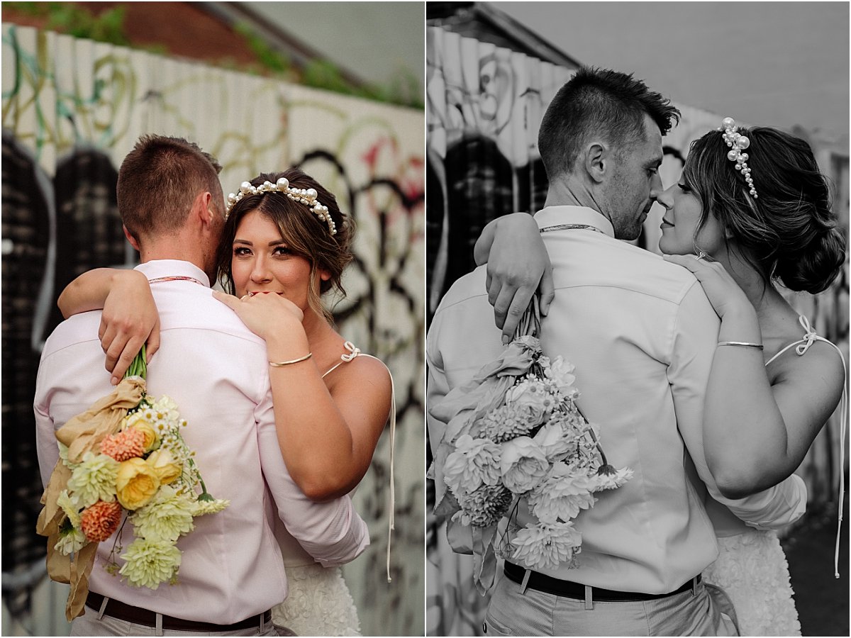Bride and groom sharing a hug together in grafitti alleyway in Islington Newcastle NSW